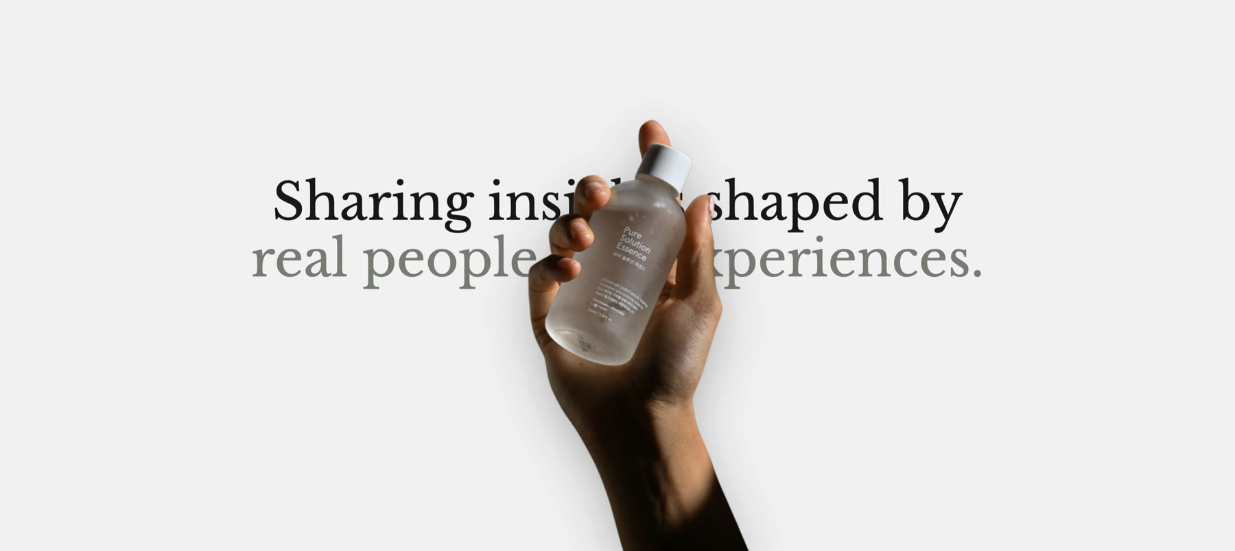 Headline with a hand holding a serum bottle layered on top